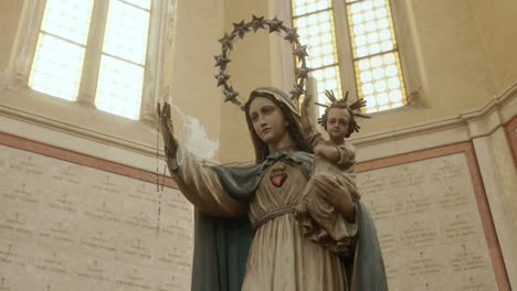 Statue-of-Madonna-With-Child-And-Rosary-Inside-The-Ossuary-Temple-In-Bassano-del-Grappa,-Italy