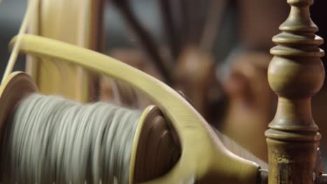 Narrow-focus-Nordic-spinning-wheel-spins-grey-wool-yarn-onto-bobbin