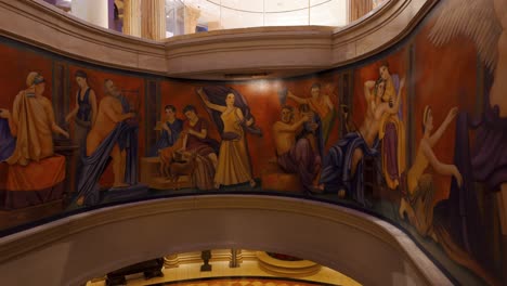 POV-Taking-Escalator-Down-At-Caesars-Palace-With-Roman-Paintings-On-the-Walls