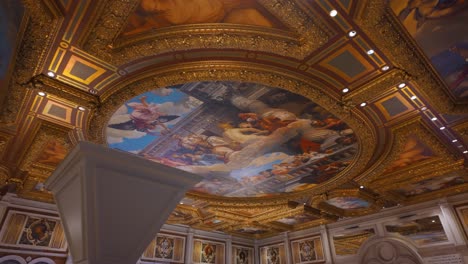 Looking-up-at-painted-mural-and-gold-decoration-on-ceiling-at-Venetian-Resort,-Las-Vegas