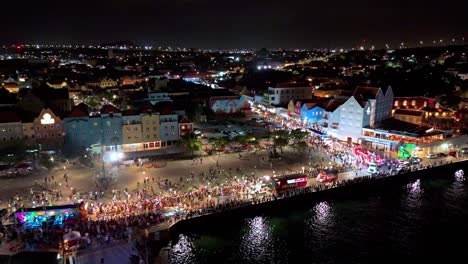 Aerial-pullback-as-light-shimmers-on-water-from-Carnaval-gran-marcha-at-night