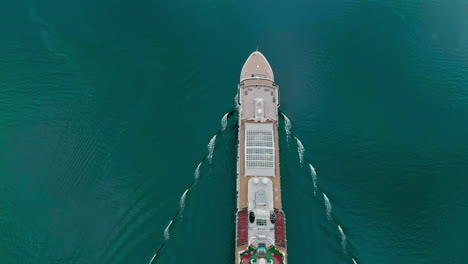 Cruise-ship-heading-out-on-a-luxury-vacation-voyage---straight-down-aerial-view