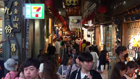 Large-crowds-of-people-explore-the-quaint-mountain-village-town-of-Jiufen's-Old-Street,-popular-tourist-attraction-in-Taiwan