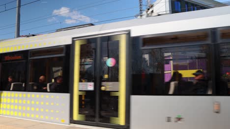 Tram-Stopping-By-Old-Trafford-Stadium-In-Manchester,-England,-static-shot