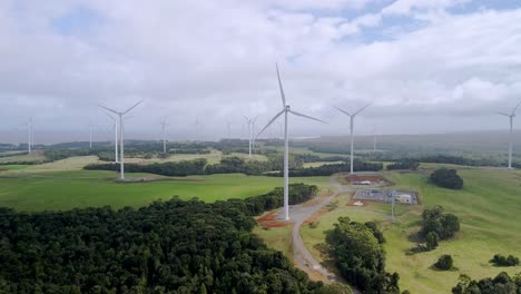 Drone-shot-of-wind-farm-turbines-with-spinning-propellers-generating-renewable-green-energy-in-Tasmania,-Australia