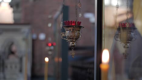 Handheld-shot-of-candles-in-a-church-with-a-dramatic-focus-pull