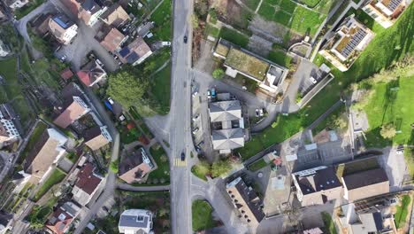 Dron-view-captures-town-view-from-top-of-Walensee-Wessen-Switzerland-shows-houses,-roads,-vehicles,-people-and-greenery-in-side