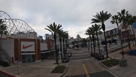 Wide-angle-view-of-a-quiet-Long-Beach-street-with-rollercoaster,-overcast-sky,-fisheye-lens