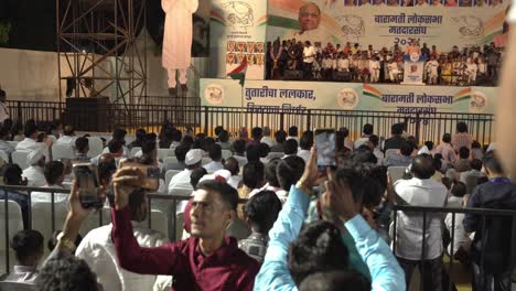 Supporters-capturing-Lok-Sabha-election-campaign-speech-by-Uddhav-Thackeray-and-Sharad-Pawar-at-college-ground-in-Warje