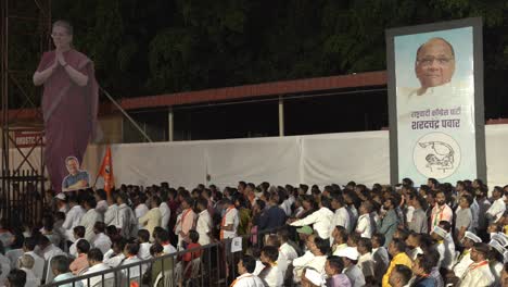 Indian-people-participating-in-Lok-Sabha-election-campaign-by-Uddhav-Thackeray-at-college-ground-in-Warje,-Congress-leader-Sonia-Gandhi-and-Rajya-Sabha-member-Sharad-Pawar-promotional-display