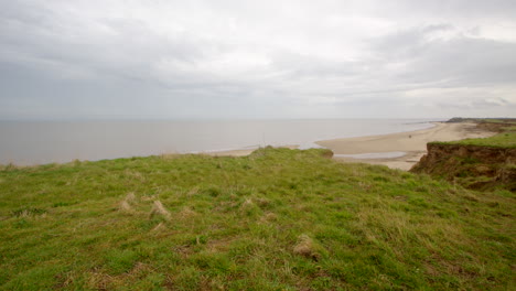 Panning-wide-shot-of-coastal-erosion-looking-South-at-Happisburgh-in-March-2024
