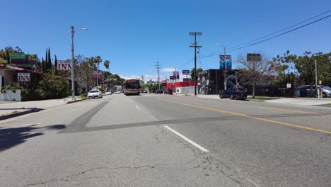 El-Autobús-Urbano-Del-Metro-Viaja-Por-Una-Calle-Muy-Transitada---Toma-De-Seguimiento