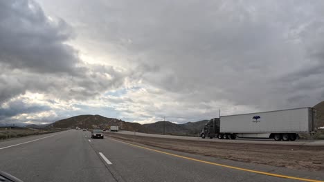 Cloudy-skies-over-Tehachapi-during-a-driving-timelapse,-showcasing-a-dynamic-and-moody-atmosphere