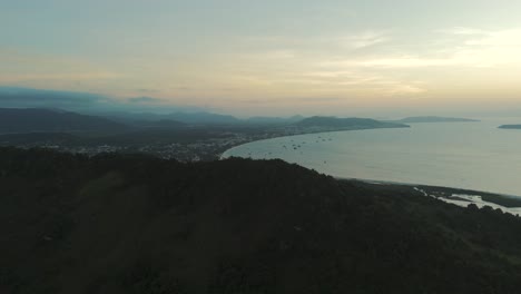 Witness-a-breathtaking-sunset-over-Ponta-das-Canas-and-Canavieiras-Beaches,-painting-the-sky-with-vibrant-hues-and-casting-a-golden-glow-over-the-picturesque-coastline