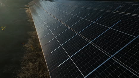 Aerial-view-in-front-of-a-Solar-collector-array-on-a-field,-sunny-autumn-day