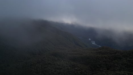 Flying-through-clouds-above-forest-of-New-Zealand