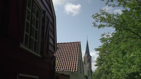 View-on-Wassenaar-church-spire-and-Dutch-architecture-rooftops-in-summer