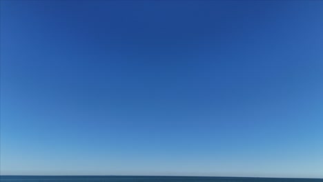 Drone-shot-of-sky-tilting-down-to-reveal-Lake-Ontario