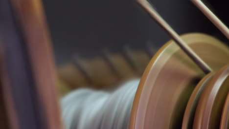 Narrow-focus-close-up:-Yarn-on-bobbin-of-antique-Nordic-spinning-wheel