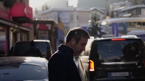 Man-on-the-phone-in-the-middle-of-Davos-high-street-during-the-World-Economic-Forum