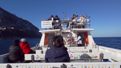 People-Sitting-On-Deck-Of-Boat-During-Tour-in-Capri-Island,-Italy