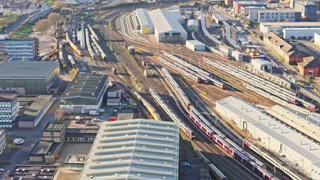 A-cinematic-shot-of-a-running-train-caught-on-a-camera-from-the-air-in-Derby,-UK