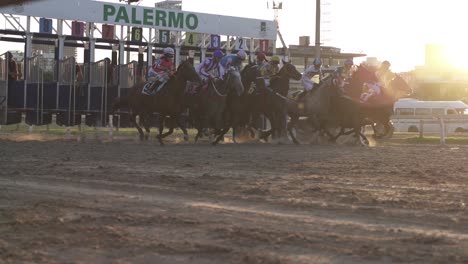 Start-of-horserace-with-Running-Horses-at-racecourse-of-Palermo-in-Buenos-Aires-during-golden-Sunset