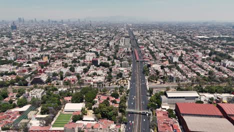 Aerial-view-of-bustling-Calzada-de-Tlalpan-on-a-sunny-Sunday-in-southern-Mexico-City