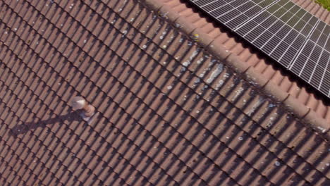 Rooftop-tiles-with-solar-panels,-aerial-top-down-view