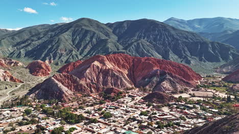 Hyperlapse-approaches-Purmamarca,-revealing-its-iconic-Seven-Color-Mountain-in-the-background