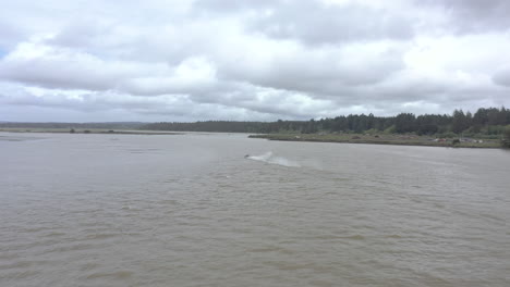 2024-UIM-World-Jet-Boat-River-Racing-Championship-in-Bandon-Oregon,-drone-follows-speed-boat