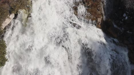 Aerial-shot-of-the-majestic-Owen-Sound-waterfall-in-Ontario,-cascading-waters,-surrounded-by-forest