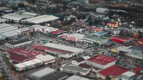 Shopping-mall,-parking,-and-residential-quarter-of-a-small-town-in-rural-Germany,-aerial-view