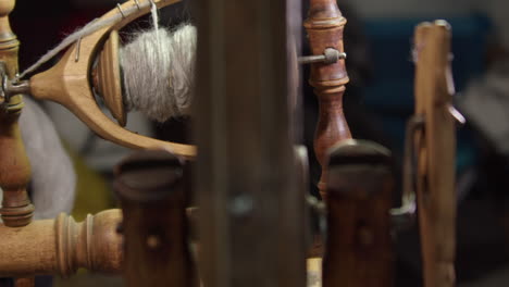 Closeup:-Wool-spun-into-grey-yarn-on-antique-Nordic-spinning-wheel