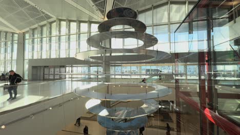 Interior-view-of-Newark-Airport,-showcasing-modern-architecture-and-travelers,-panning-upwards-shot