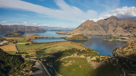 Cloud-shadows-quickly-move-across-Lake-Wanaka,-landscape,-New-Zealand-aerial-timelapse