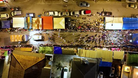 Drone-bird's-eye-view-above-carnaval-performers-dancing-in-streets-to-celebrate