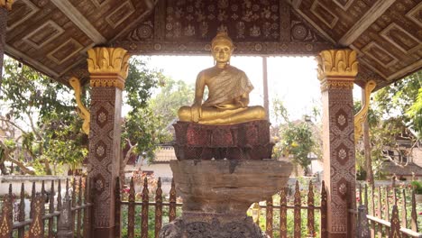 outdoor-buddhist-statue-in-pavilion-in-Luang-Prabang,-Laos-traveling-Southeast-Asia