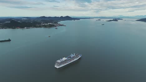 Drone-shot-of-a-cruise-ship-sailing-in-the-middle-of-Babitonga-bay,-Santa-Catarina