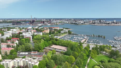 Aerial-view-away-from-the-Lauttasaari-marina,-sunny,-spring-day-in-Helsinki
