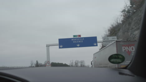 Overhead-road-sign-from-car-window,-highway-direction-Marseille,-Valence