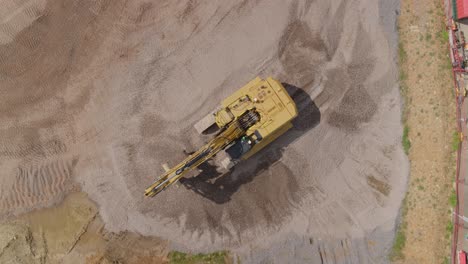 Top-down-aerial-of-a-large-machinery-digger-working-on-a-construction-site