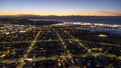 Evening-aerial-timelapse-over-coastal-city-of-Nelson,-New-Zealand,-city-traffic
