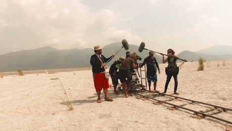 director-commands-production-shoot-behind-the-scenes-with-wide-follow-shot