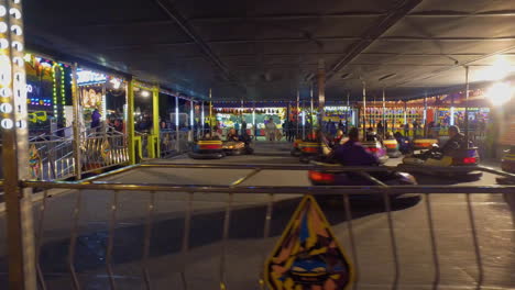 Fall-Fair-Medium-shot-dollys-along-as-people-ride-in-bumper-cars