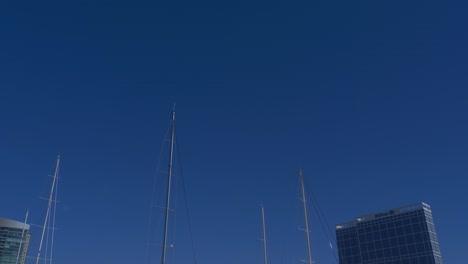 Tilt-down-shot-of-the-pier-with-superyachts-including-Dum-Luck-and-New-Secret-parked-alongside-the-Hilton-hotel-and-SD-convention-center