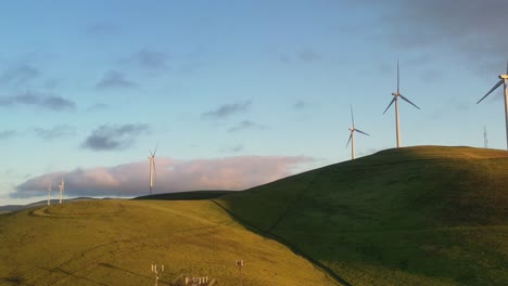 Wind-Turbines-Spinning-on-Hillside---Sunset