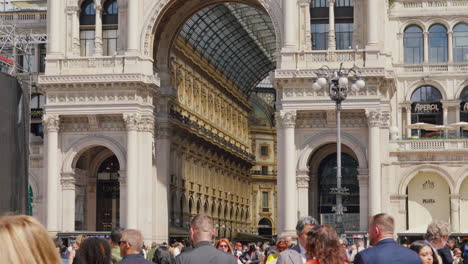 Bustling-crowd-outside-historic-Milanese-arcade-in-Italy