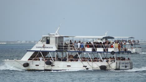 Telephoto-shot-of-a-full-cruise-ship-ferry-boat-carrying-passengers