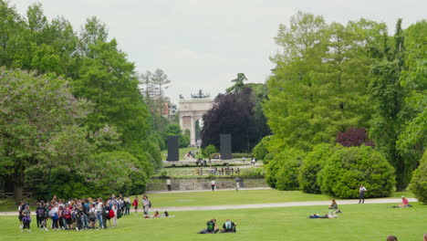 Milan-park-scene-with-people-and-historic-arch-in-distance